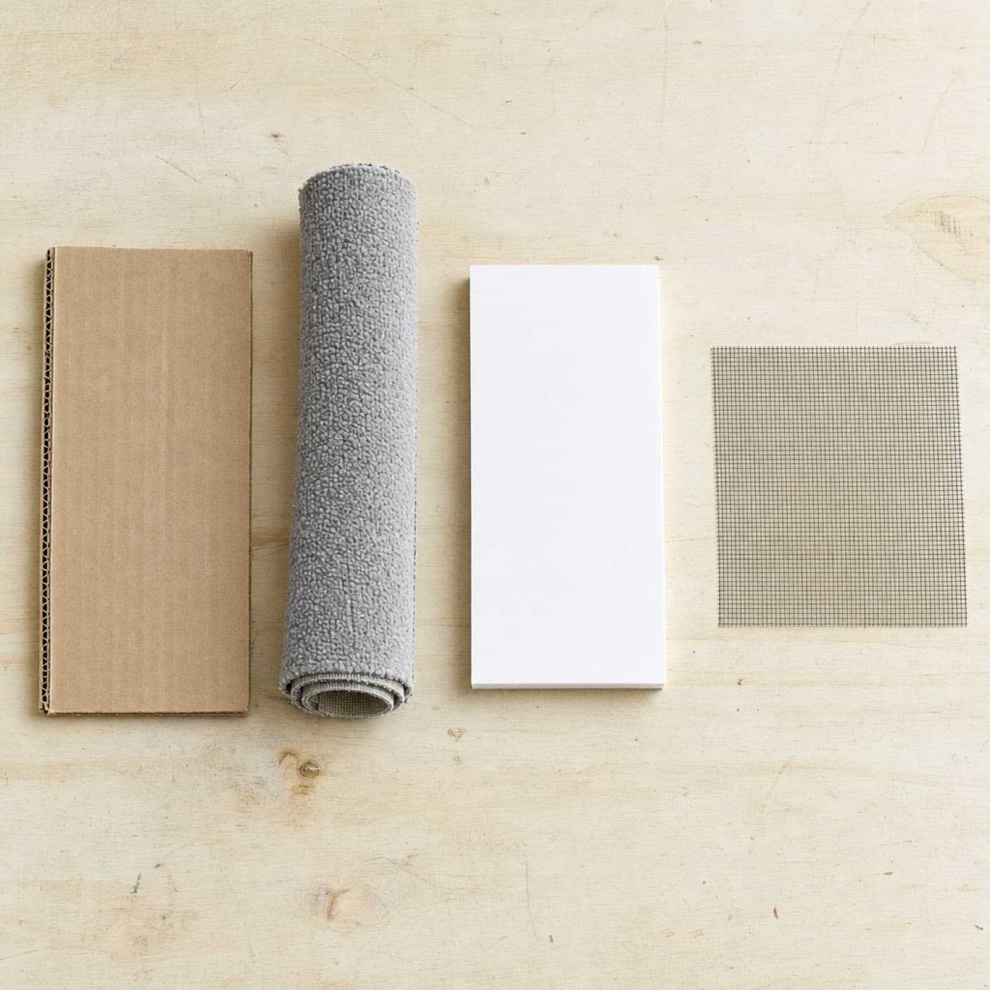 Thick double-wall cardboard, rigid board and screen mesh on a worktable